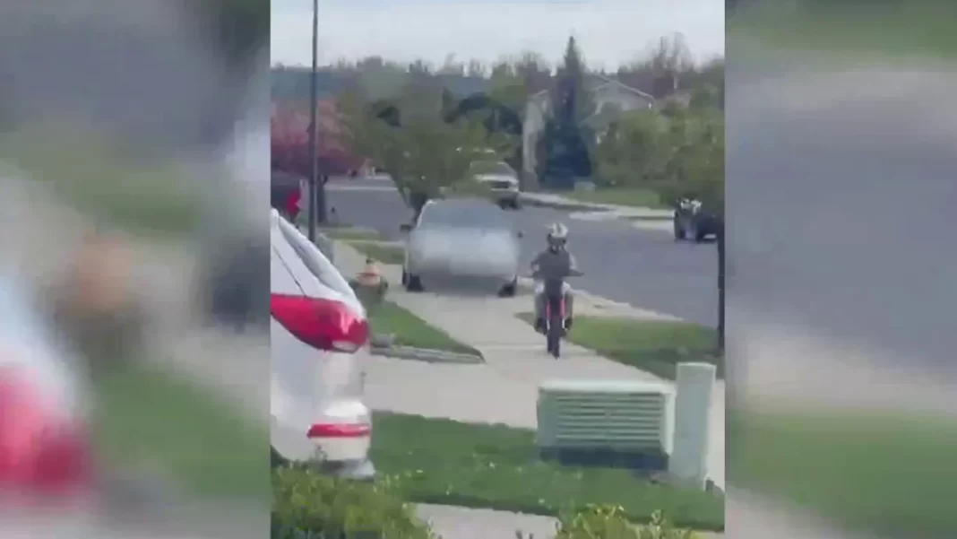 Driver arrested after video shows her hopping curb to chase child riding motorbike