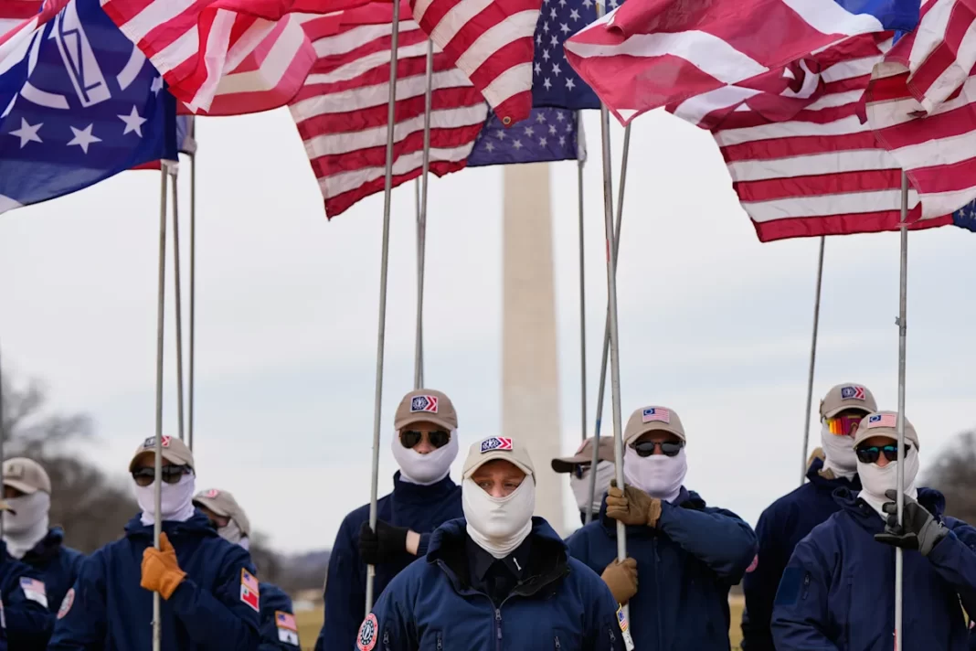 Demonstrators in white supremacist attire protest on Capitol Hill